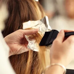 Woman in a salon chair getting her hair colored